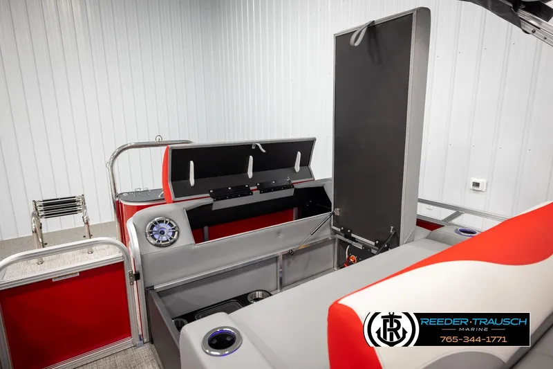 Slide: The Image of 2026 Avalon LSZ Vrl boat interior with red and gray seating, storage, and speaker system. - 24