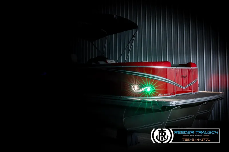 Slide: The Image of 2026 Avalon LSZ Vrl boat with sleek red design and illuminated lights in a dimly lit setting. - 4