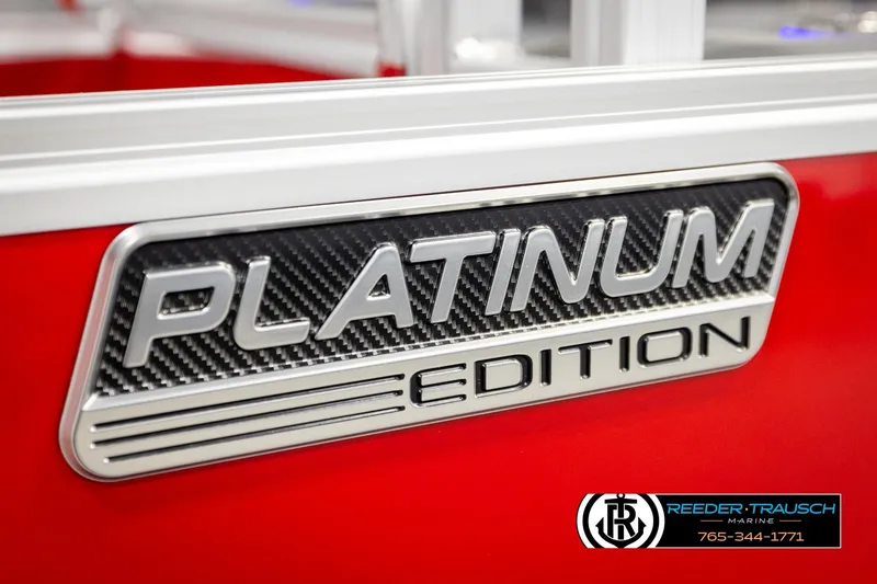 Slide: The Image of 2026 Avalon LSZ Vrl Platinum Edition badge on red surface, Reeder-Trausch Marine logo. - 48