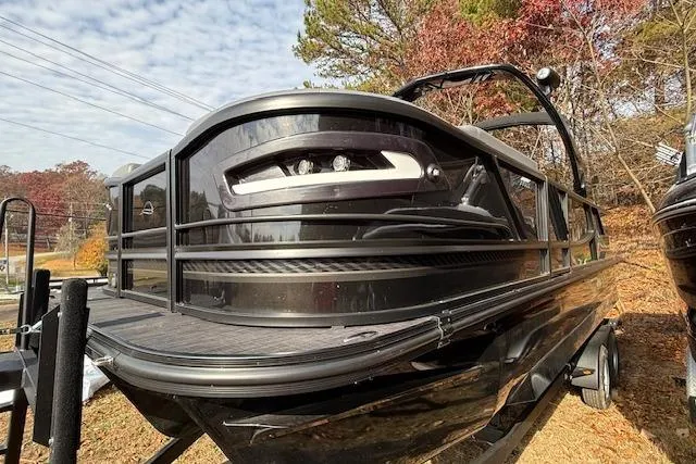 The Image of 2026 SunCatcher Diamond Elite 324 SL pontoon boat on trailer, parked outdoors. - 0