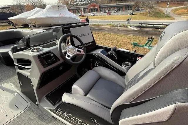 Slide: The Image of 2026 SunCatcher Diamond Elite 324 SL interior with luxurious seating and canopy in a wooded setting. - 24