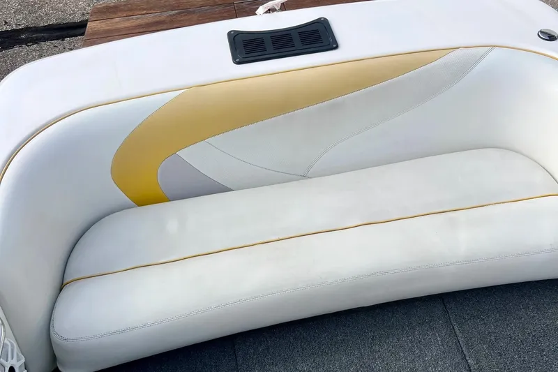 Slide: The Image of White and yellow seating on a 2002 Malibu Sportster LX boat. - 10