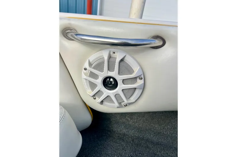 Slide: The Image of 2002 Malibu Sportster LX interior with speaker and chrome handle detail. - 11