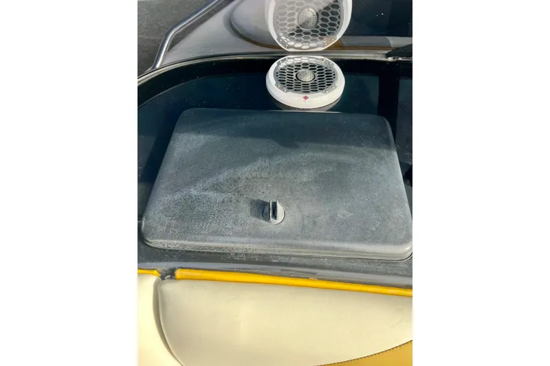 Slide: The Image of 2002 Malibu Sportster LX dashboard with speakers and storage compartment. - 15