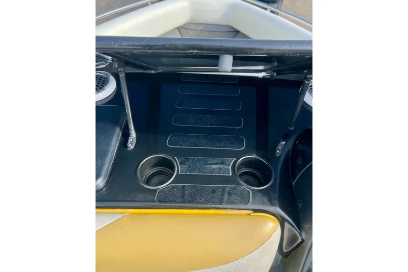 Slide: The Image of 2002 Malibu Sportster LX boat interior with cup holders and seating area. - 16