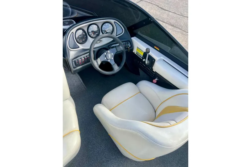 Slide: The Image of 2002 Malibu Sportster LX boat interior with steering wheel and dashboard controls. - 18