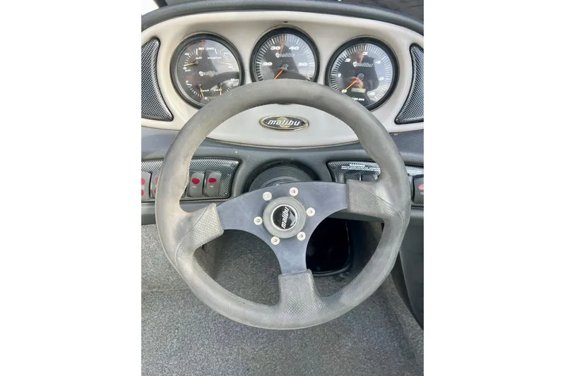 Slide: The Image of Steering wheel and dashboard of a 2002 Malibu Sportster LX boat. - 20