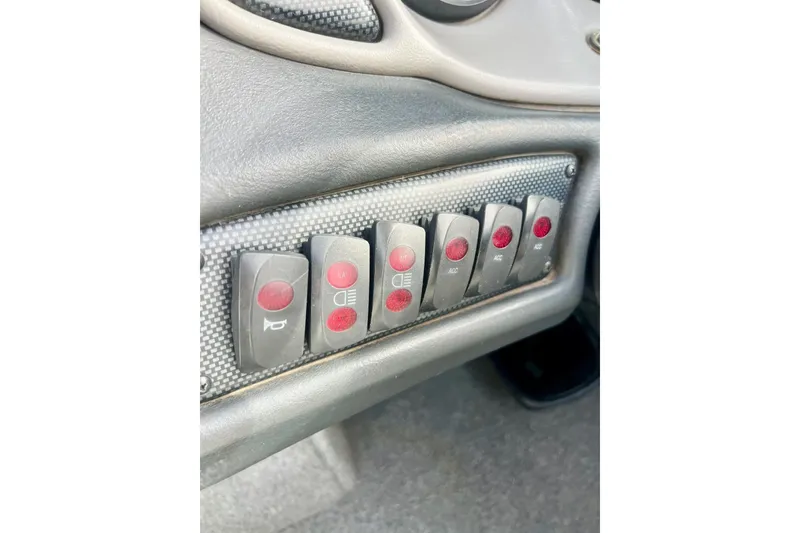 Slide: The Image of Dashboard control panel of a 2002 Malibu Sportster LX with multiple switches. - 21
