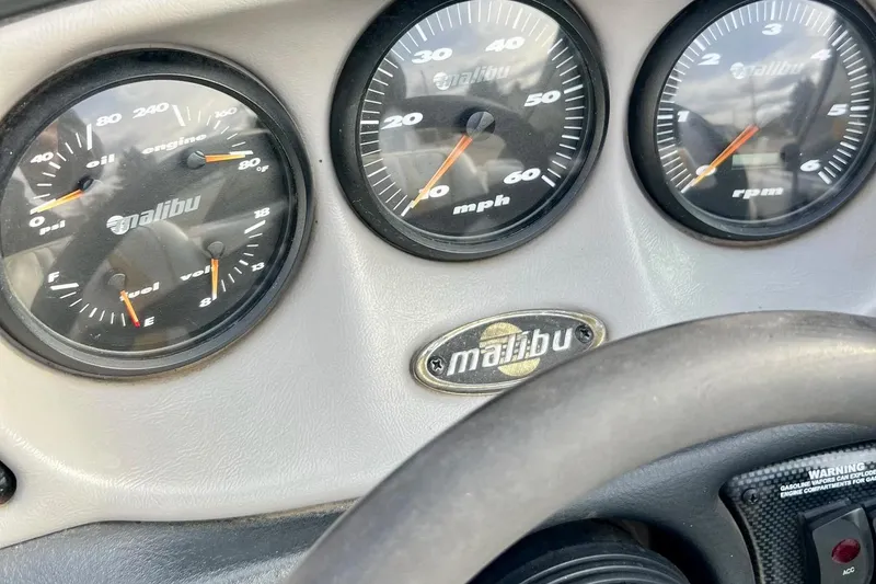 Slide: The Image of Dashboard of a 2002 Malibu Sportster LX showing gauges and logo. - 22