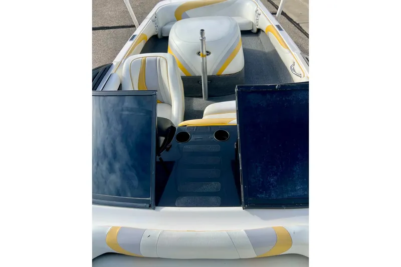 Slide: The Image of 2002 Malibu Sportster LX boat interior with yellow accents and seating arrangement. - 29