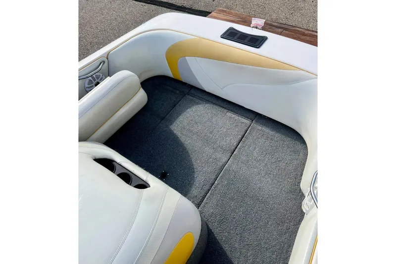 Slide: The Image of 2002 Malibu Sportster LX boat interior with white and yellow seating, gray carpet. - 34