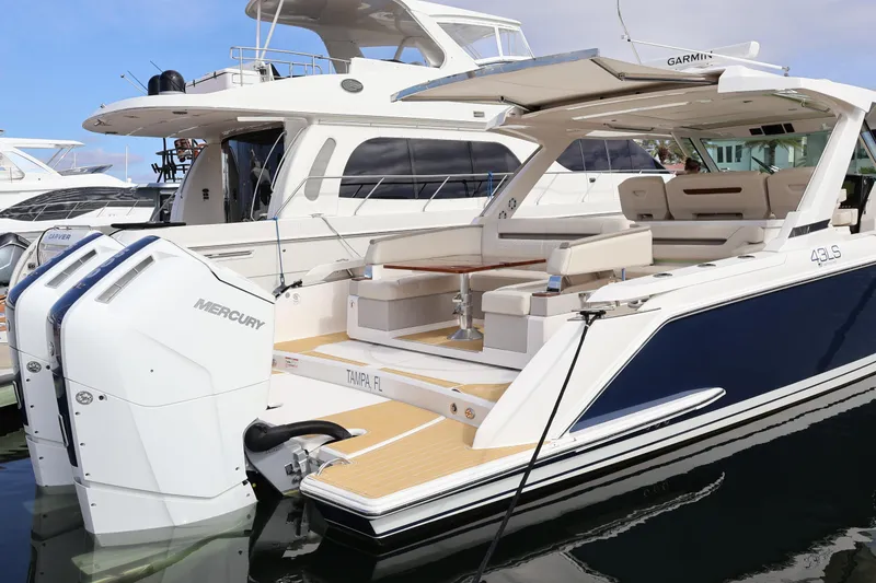 Slide: The Image of 2023 Tiara Yachts 43 LS luxury boat with Mercury engines docked in marina. - 13