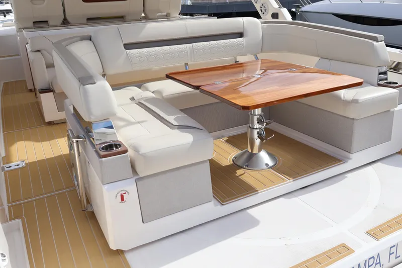Slide: The Image of Luxurious seating area on 2023 Tiara Yachts 43 LS with elegant wooden table. - 15