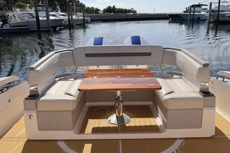 Slide: The Image of 2023 Tiara Yachts 43 LS luxury boat interior with elegant seating and wooden table. - 18