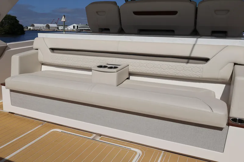 Slide: The Image of Luxurious seating on 2023 Tiara Yachts 43 LS, featuring elegant design and cup holders. - 24