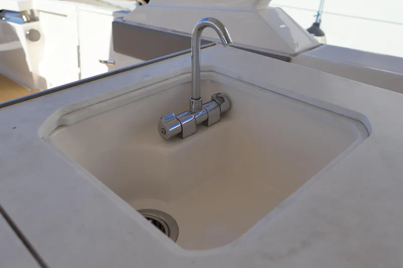 Slide: The Image of Luxury yacht sink on 2023 Tiara Yachts 43 LS, featuring sleek design and modern faucet. - 30