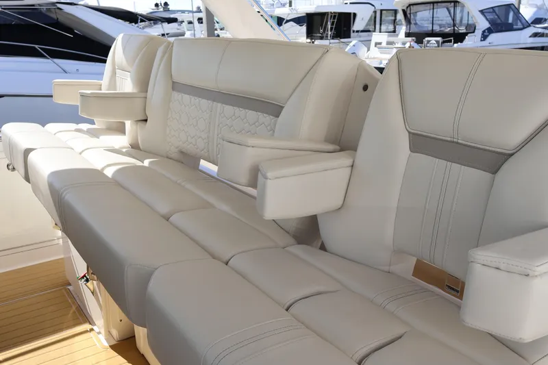 Slide: The Image of Luxurious seating on 2023 Tiara Yachts 43 LS, featuring elegant white upholstery and armrests. - 35