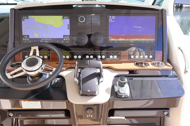 Slide: The Image of 2023 Tiara Yachts 43 LS helm with dual navigation screens and modern controls. - 40