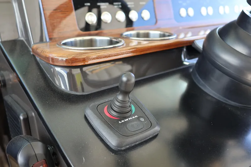 Slide: The Image of Control panel of 2023 Tiara Yachts 43 LS with joystick and cup holders. - 42