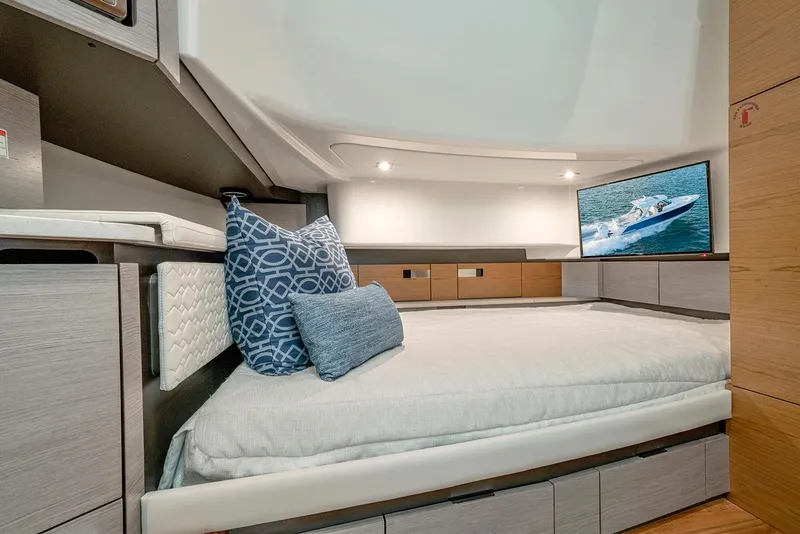 Slide: The Image of Manufacturer Provided Image: Luxurious cabin interior of 2023 Tiara Yachts 43 LS with modern bedding and TV. - 46