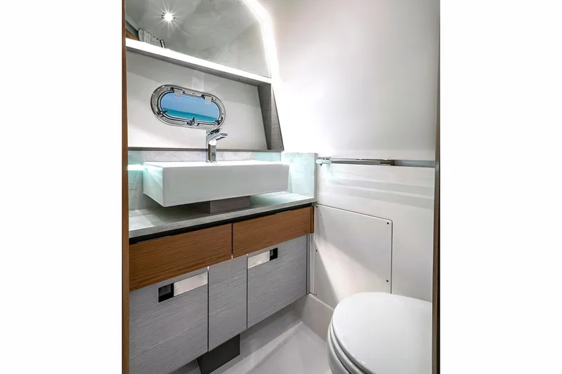 Slide: The Image of Manufacturer Provided Image: 2023 Tiara Yachts 43 LS bathroom with modern sink and porthole window. - 48