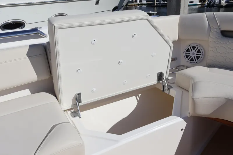 Slide: The Image of 2023 Tiara Yachts 43 LS boat seating with storage compartment and speaker. - 61