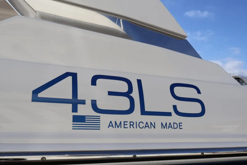Slide: The Image of 2023 Tiara Yachts 43 LS, American-made, boat exterior detail with blue sky background. - 68