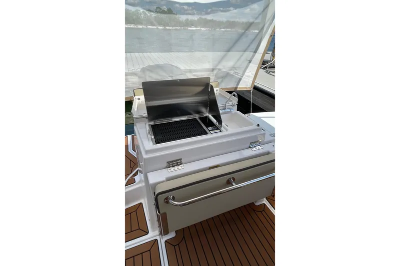 Slide: The Image of Outdoor grill on 2025 Ranger Tugs R-27 Seakeeper Ride boat deck. - 15