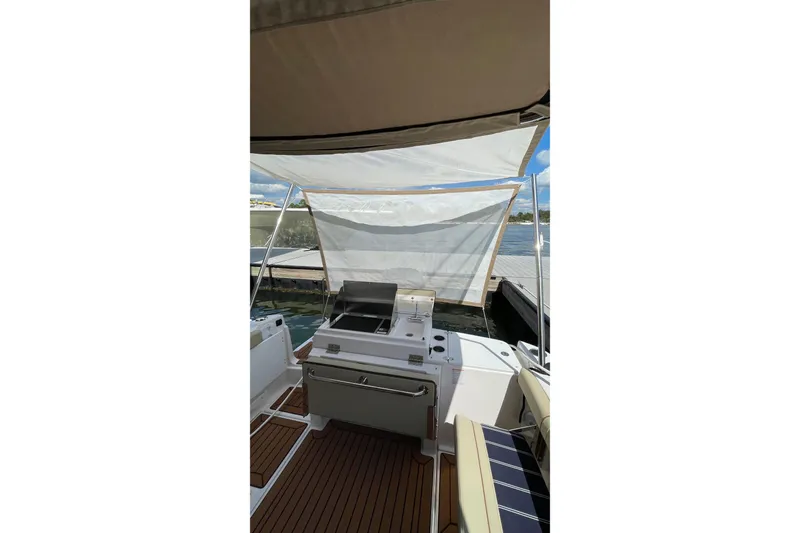 Slide: The Image of 2025 Ranger Tugs R-27 Seakeeper Ride with outdoor kitchen and canopy on deck. - 16