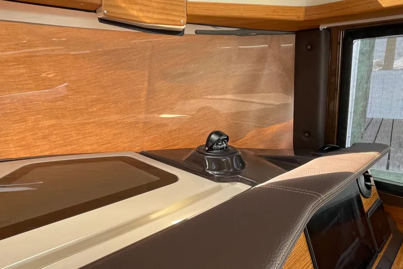 Slide: The Image of Interior view of 2025 Ranger Tugs R-27 Seakeeper Ride with wood paneling and modern design. - 24