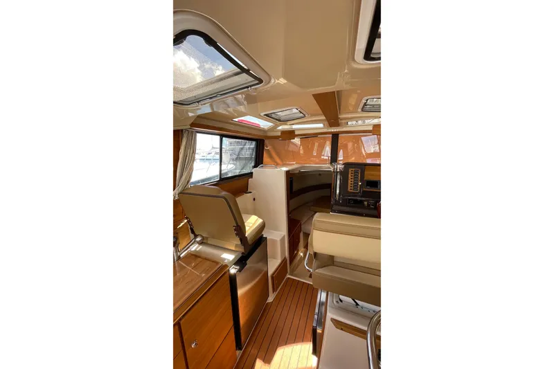 Slide: The Image of Interior of 2025 Ranger Tugs R-27 Seakeeper Ride, featuring elegant wood finishes and modern design. - 29