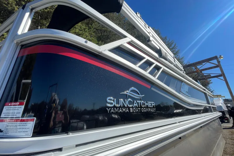 The Image of 2026 SunCatcher Select 322SL boat by Yamaha, side view under clear blue sky. - 0