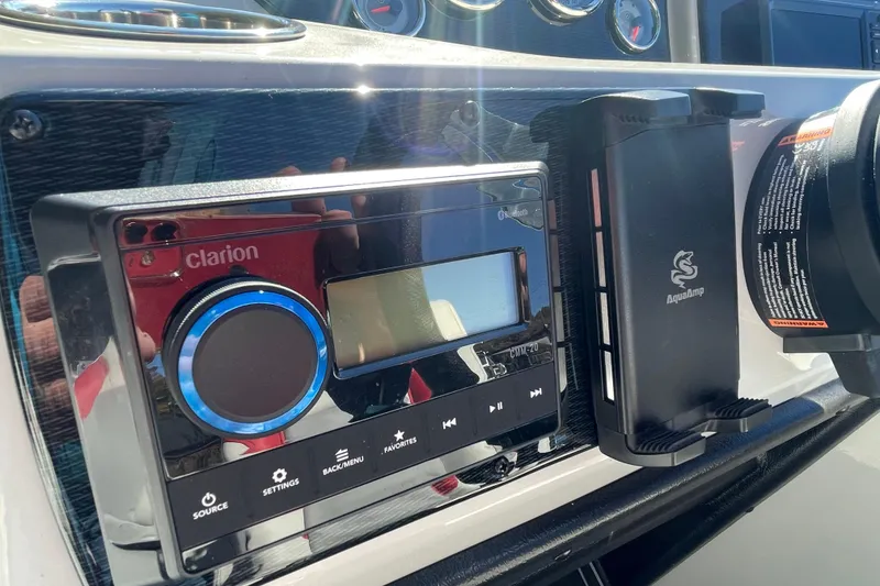 Slide: The Image of Luxurious seating on 2026 SunCatcher Select 322SL pontoon boat with red accents and cup holders. - 12