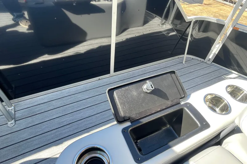 Slide: The Image of 2026 SunCatcher Select 322SL boat interior with red and gray seating, cup holders, and SunCatcher branding. - 16