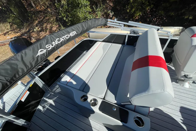 Slide: The Image of 2026 SunCatcher Select 322SL pontoon boat interior with modern seating and steering console. - 19