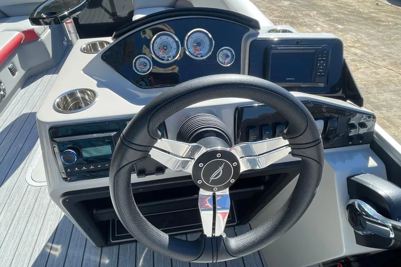 Slide: The Image of Dashboard of 2026 SunCatcher Select 322SL boat with gauges and cup holder. - 9
