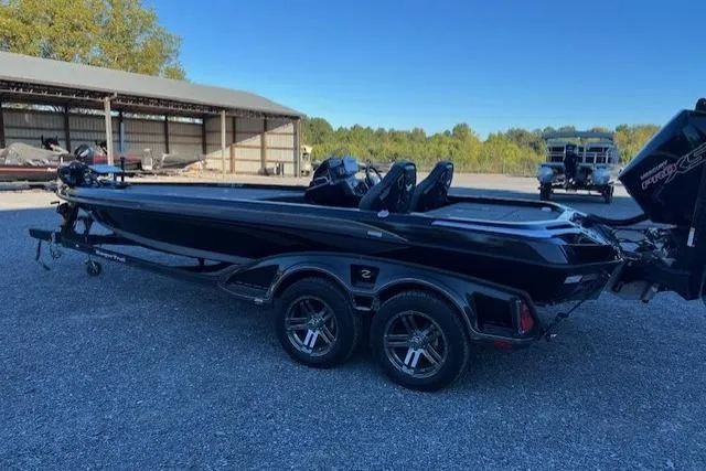 Slide: The Image of 2024 Ranger Z521R boat, black, parked outdoors on gravel, with dual-axle trailer. - 6