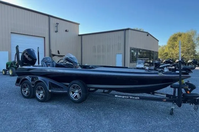 Slide: The Image of 2024 Ranger Z521R boat on trailer, parked outside industrial building. - 8