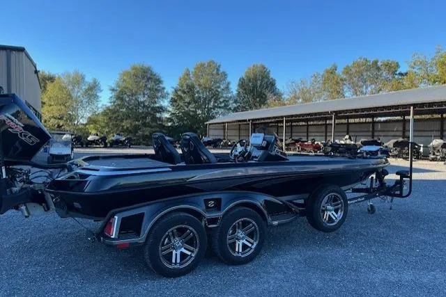 Slide: The Image of 2024 Ranger Z521R boat with dual console, parked outdoors on a trailer. - 9
