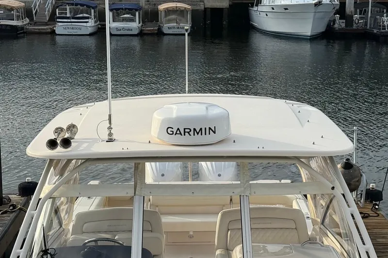 Slide: The Image of 2022 Grady-White Freedom 307 boat with Garmin equipment docked at marina. - 11