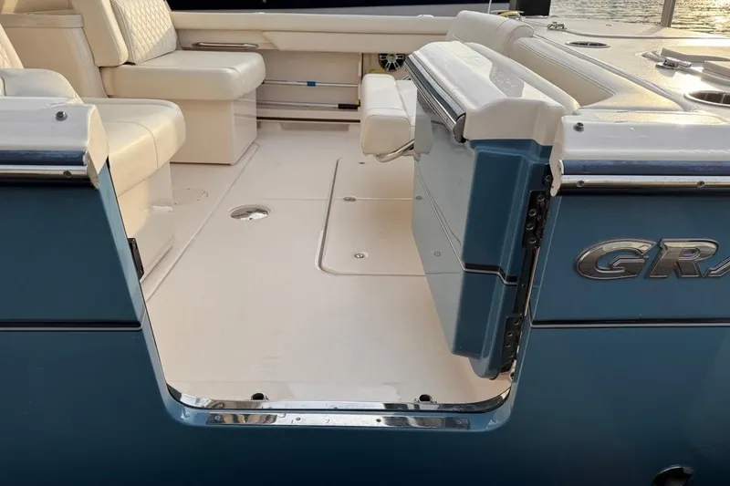 Slide: The Image of 2022 Grady-White Freedom 307 boat interior with seating and open deck view. - 15