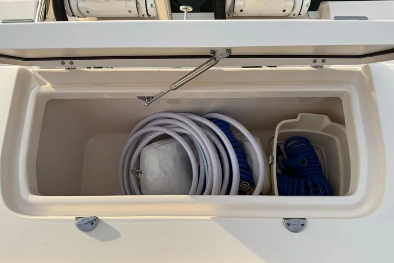 Slide: The Image of Storage compartment on 2022 Grady-White Freedom 307 boat with coiled hoses and accessories. - 20