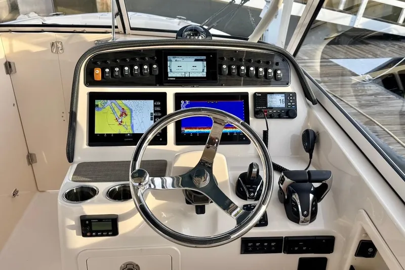 Slide: The Image of 2022 Grady-White Freedom 307 helm with advanced navigation and control systems. - 21
