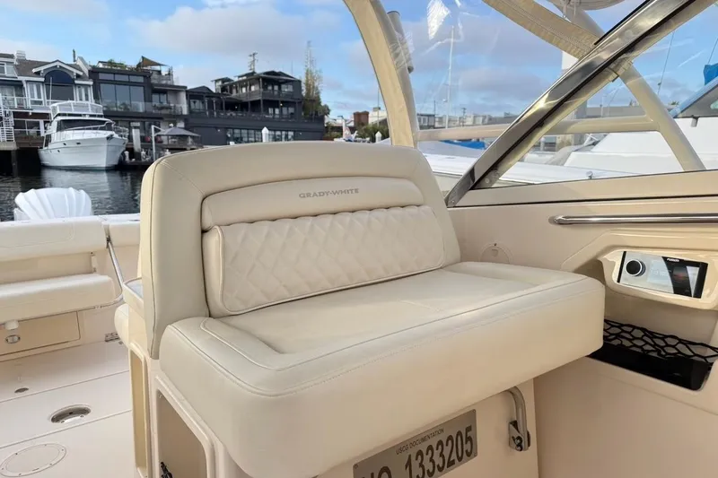 Slide: The Image of 2022 Grady-White Freedom 307 boat interior with luxurious seating and waterfront view. - 23