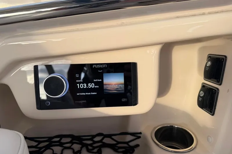 Slide: The Image of 2022 Grady-White Freedom 307 boat dashboard with Fusion radio display. - 27