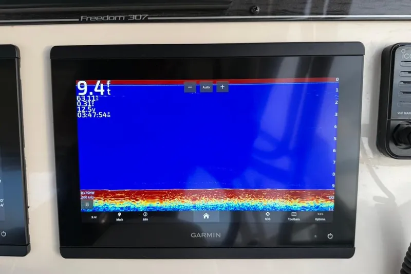 Slide: The Image of Garmin marine display on 2022 Grady-White Freedom 307 showing depth and sonar data. - 30
