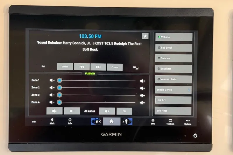 Slide: The Image of Garmin audio control panel on 2022 Grady-White Freedom 307 boat, displaying FM radio settings. - 32