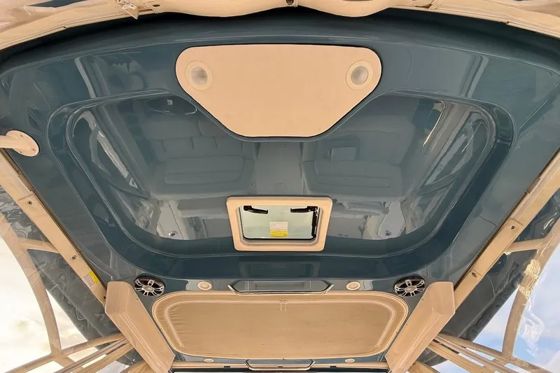 Slide: The Image of 2022 Grady-White Freedom 307 boat interior ceiling with speakers and hatch. - 33