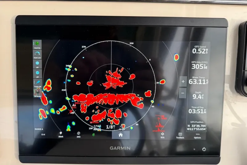 Slide: The Image of Garmin marine radar display on 2022 Grady-White Freedom 307 boat, showing navigation data. - 34