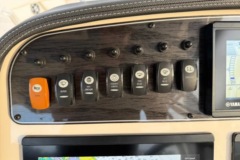 Slide: The Image of Control panel of 2022 Grady-White Freedom 307 boat with various switches and display. - 39